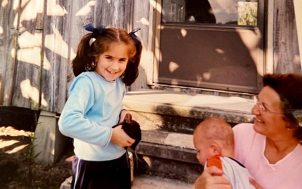 An old photo of a young girl with her grandmother. Next Avenue