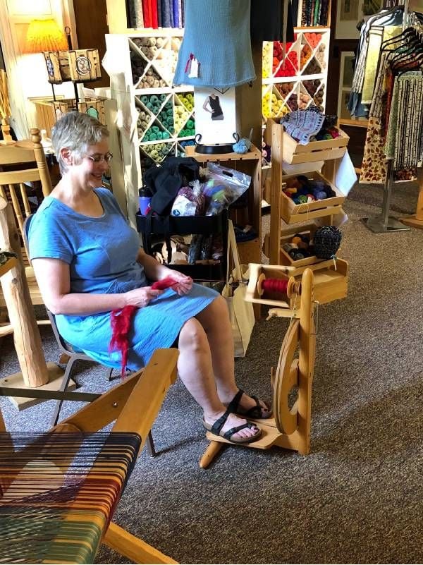 A woman using a loom. Next Avenue, Door County Wisconsin Travel