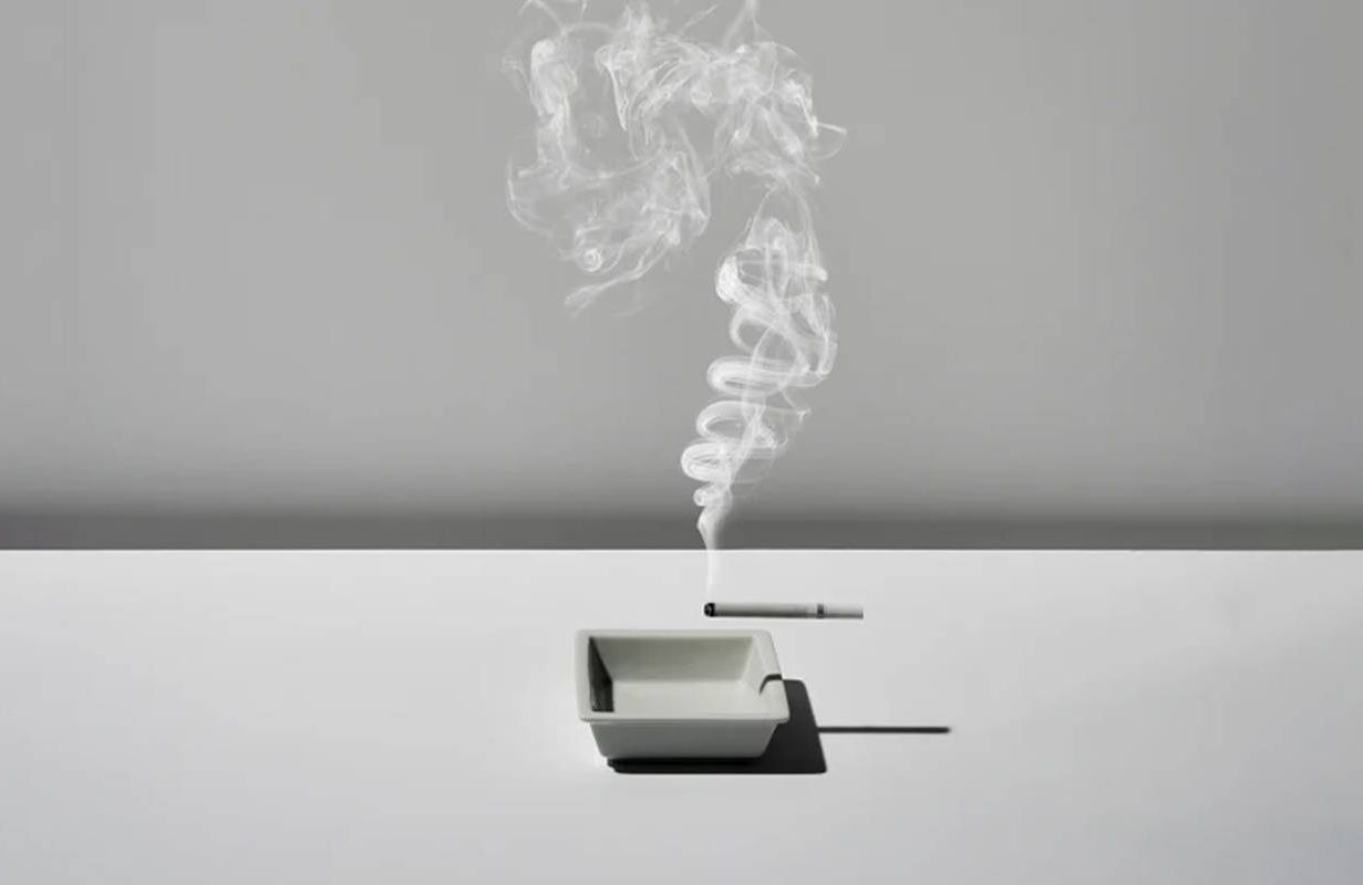 An illustration of a lit cigarette over an ashtray. Next Avenue