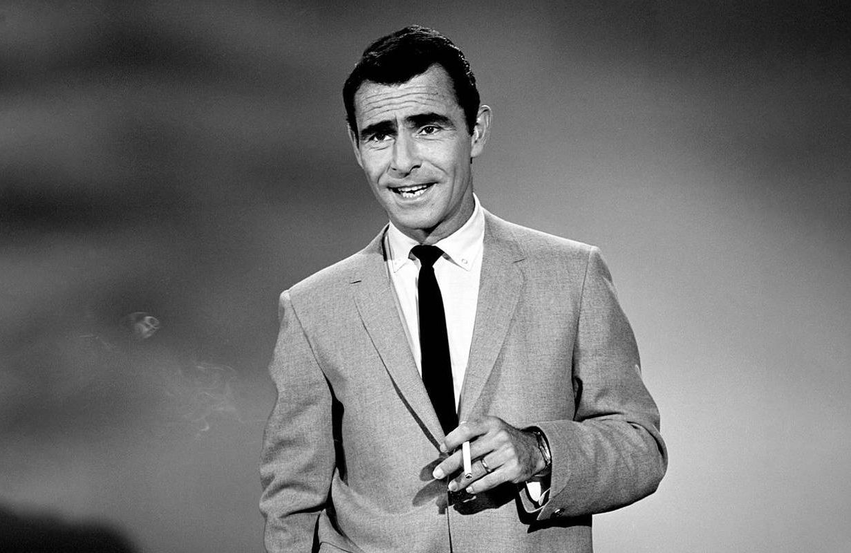 A black and white photo of a man smoking a cigarette. Next Avenue, twilight zone