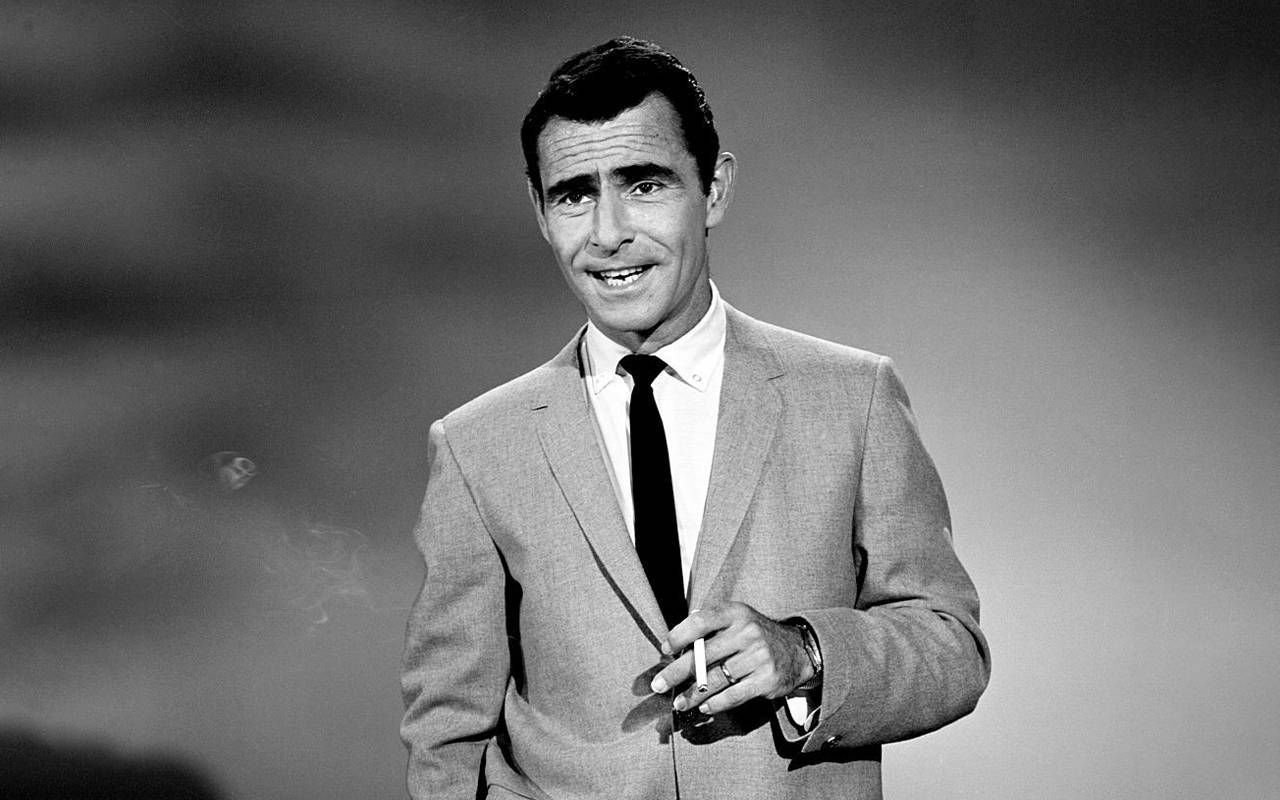 A black and white photo of a man smoking a cigarette. Next Avenue, twilight zone