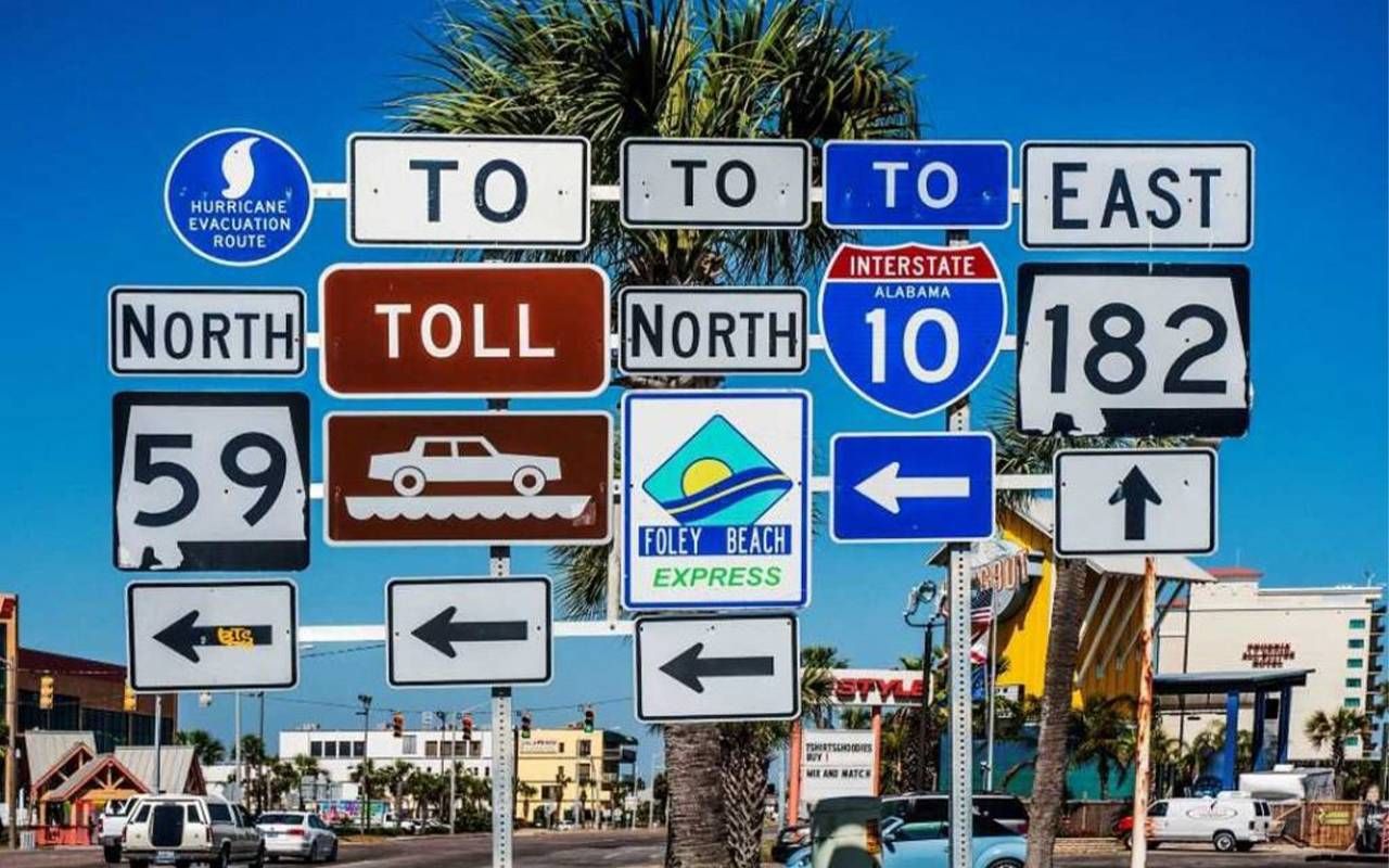 A cluttered array of signs on a street. Next Avenue