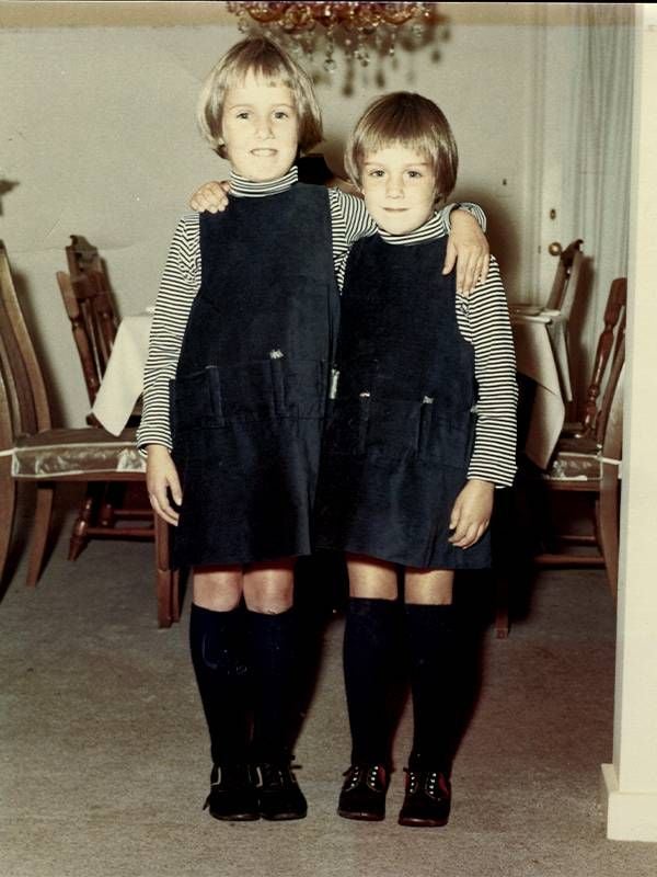 An older photo of two sisters wearing the same outfit. Next Avenue