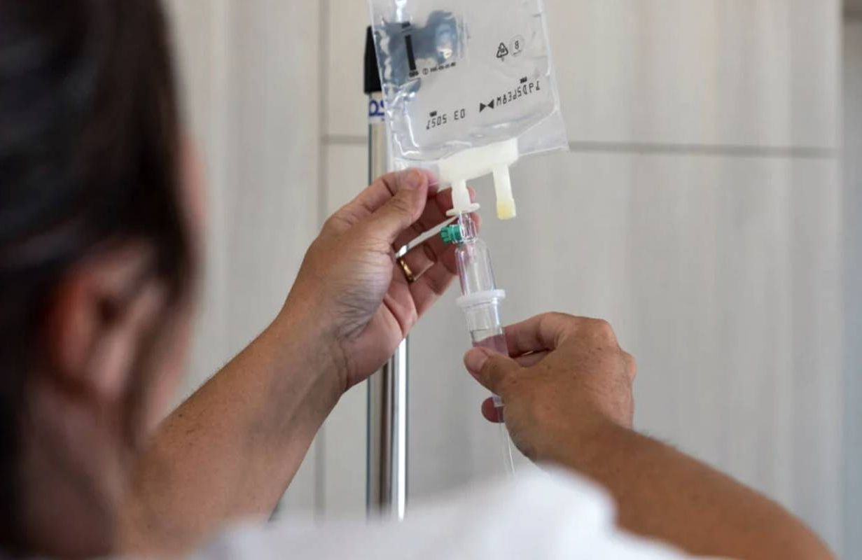 A caregiver checking an IV infusion. Next Avenue