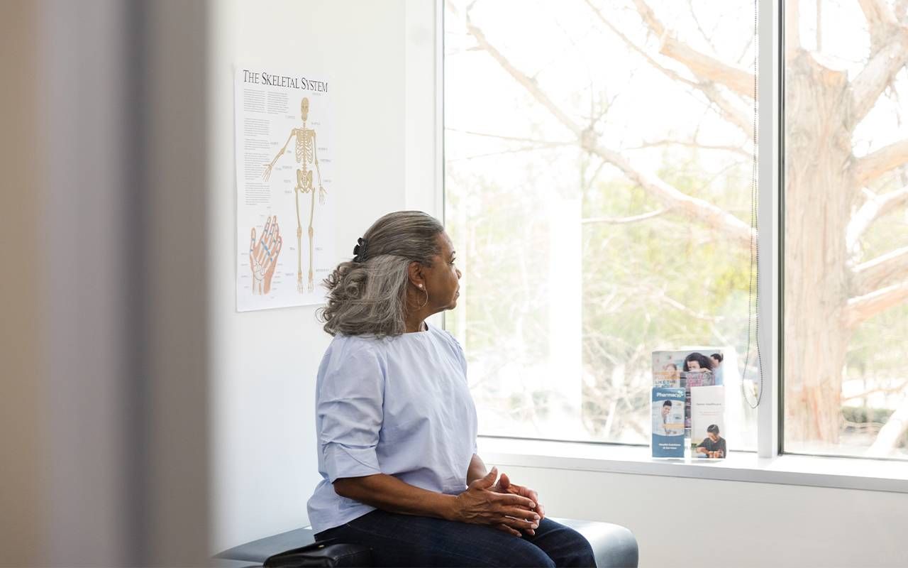 An older adult waiting for her doctor for an anxiety screening. Next Avenue