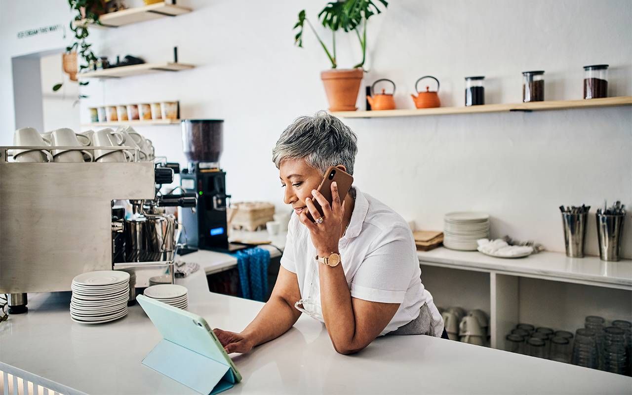 A woman working at a coffee shop taking an order. Next Avenue