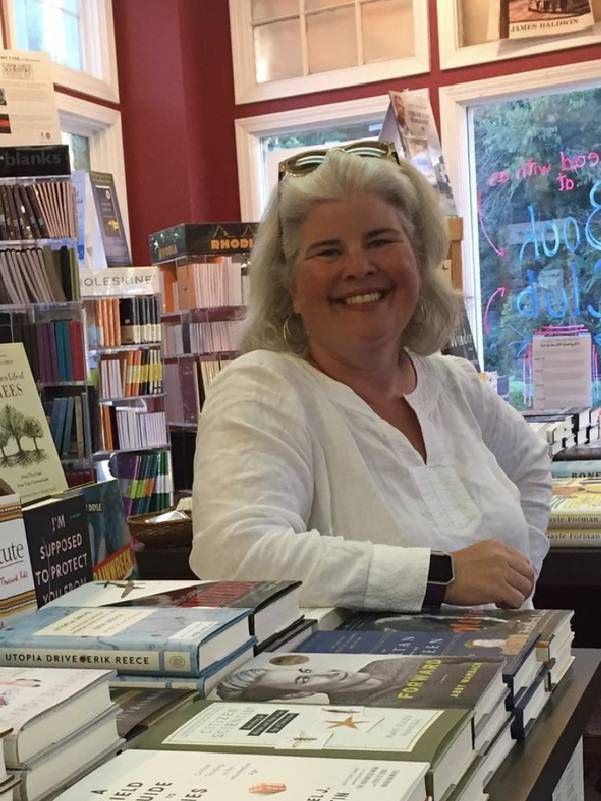 A person standing in a bookstore. Next Avenue