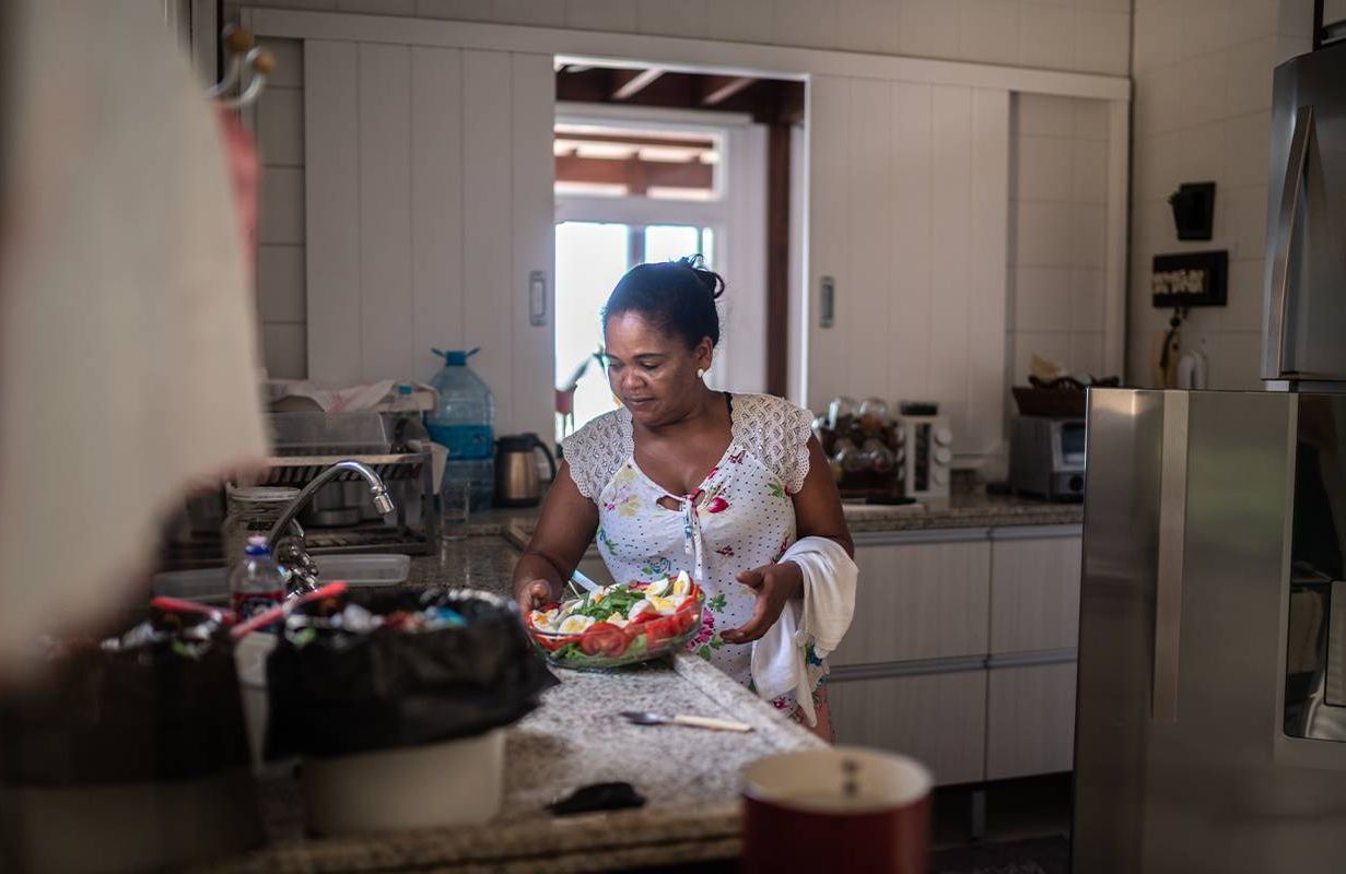 A woman making a salad at home. Next Avenue, breast cancer,