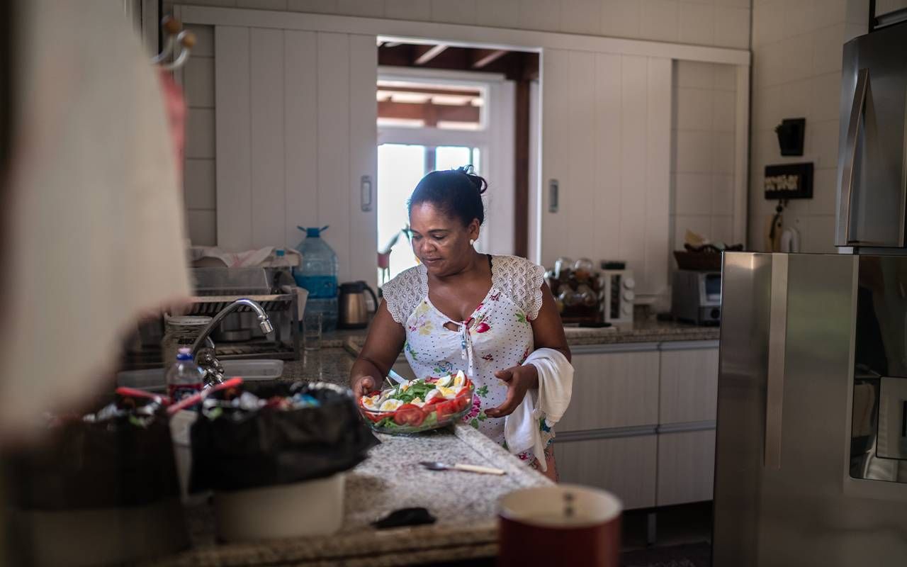 A woman making a salad at home. Next Avenue, breast cancer,