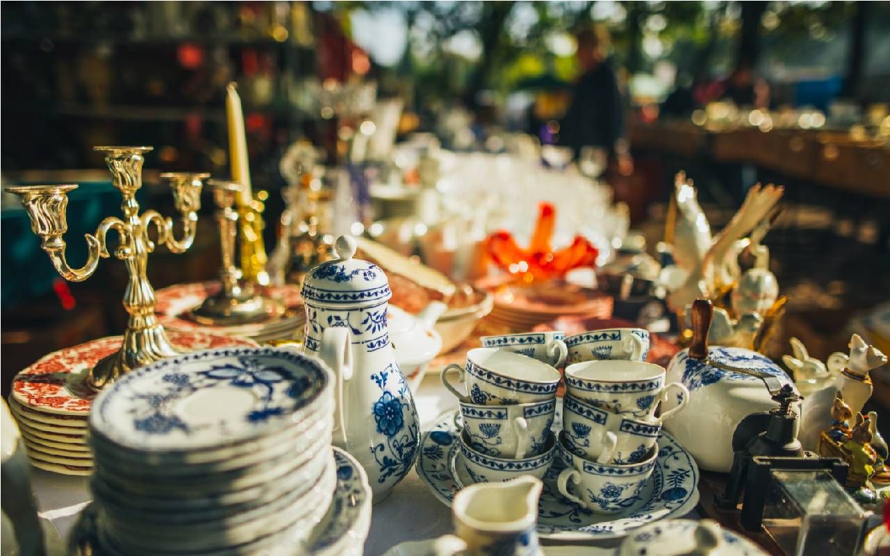 A table filled with various vintage items at a yard sale. Next Avenue