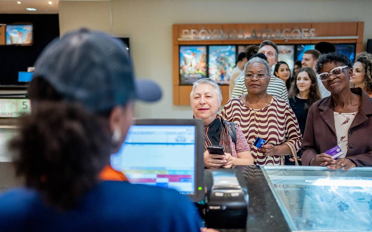 People waiting in line at a movie theater. Next Avenue