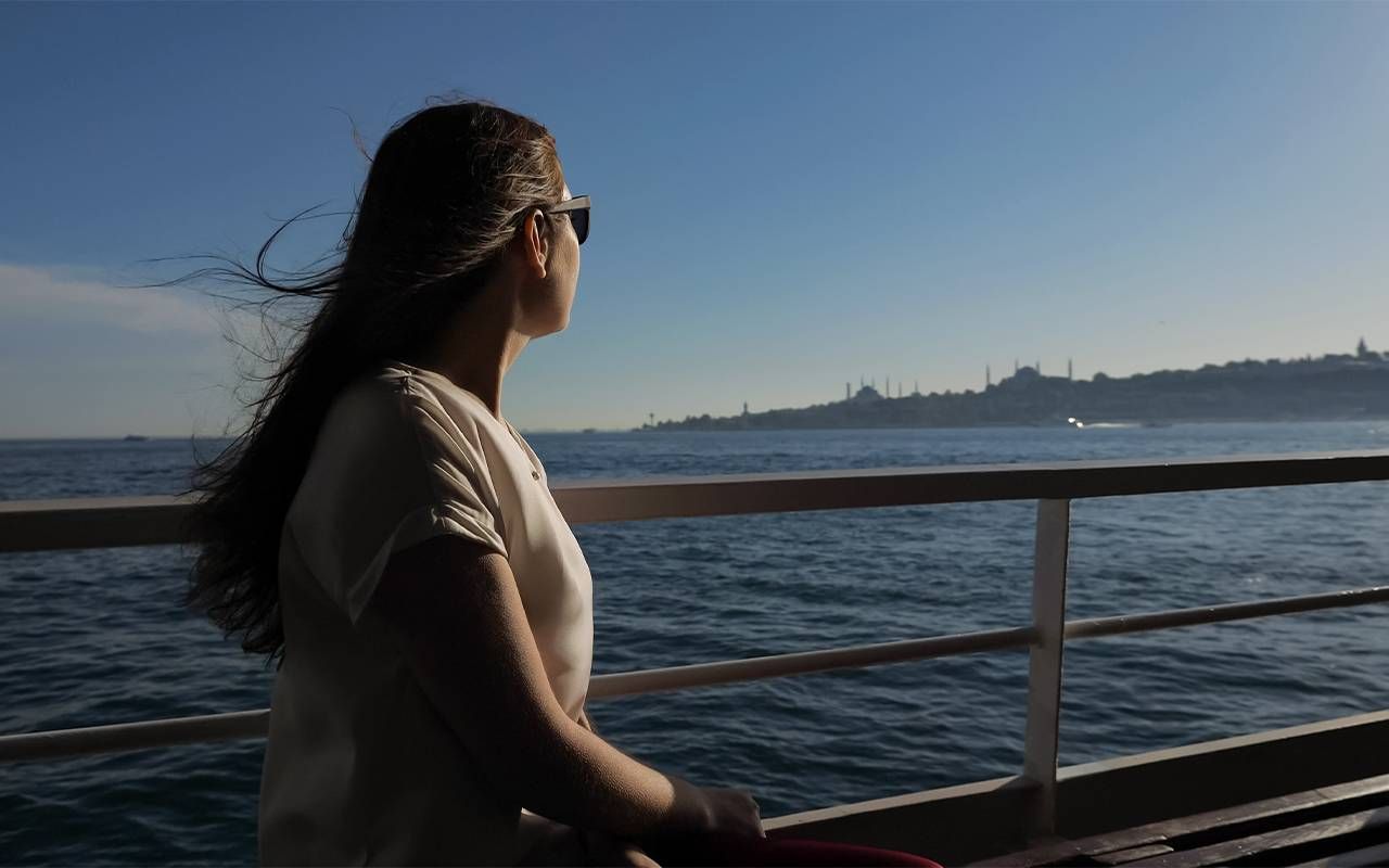 A woman looking out on the deck of a cruise ship. Next Avenue