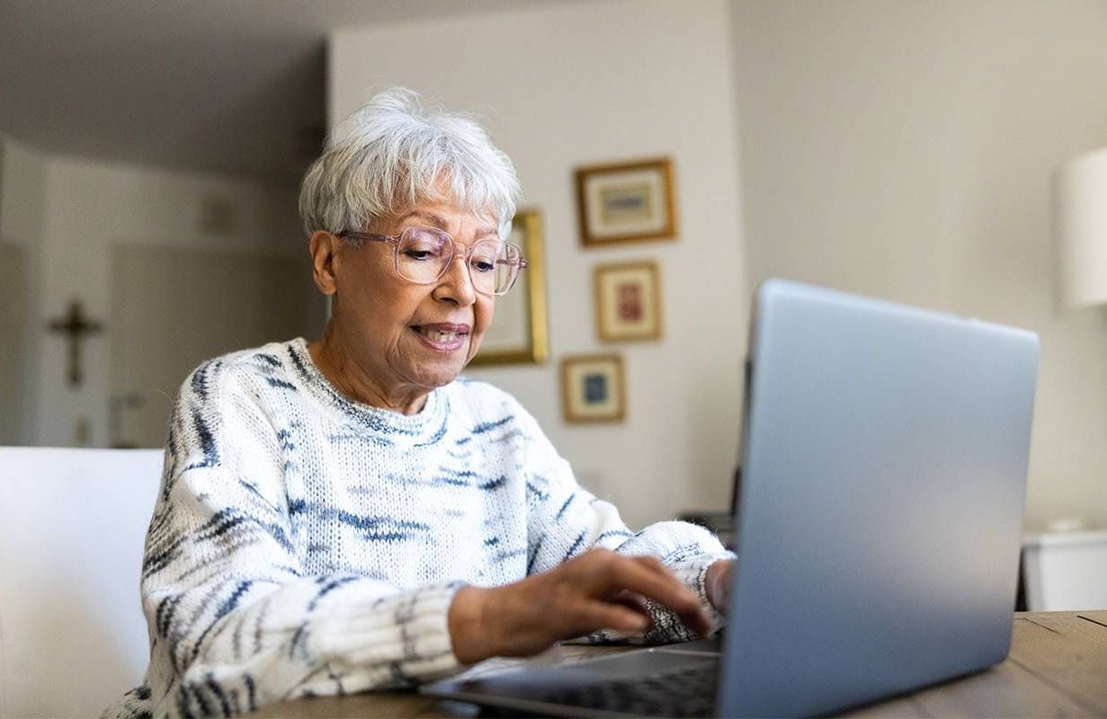 An older adult using their computer to browse the internet. Next Avenue