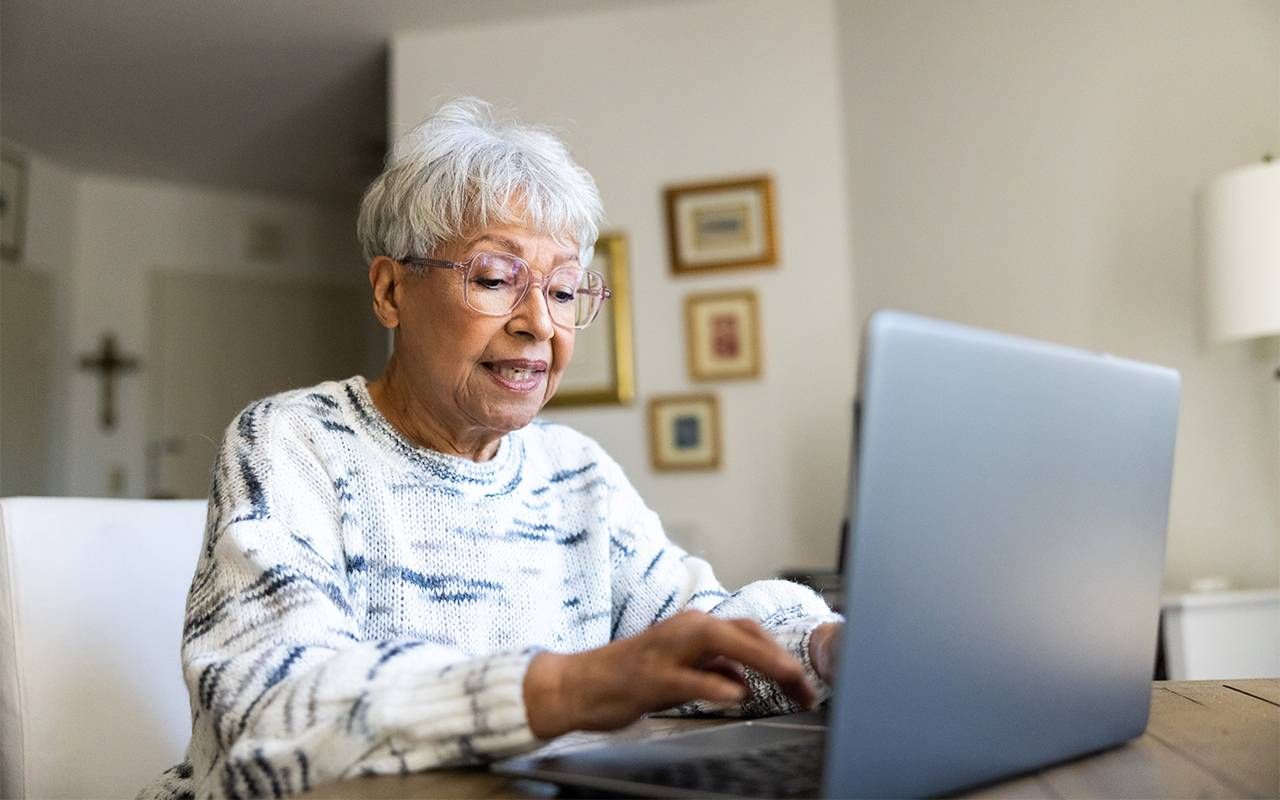 An older adult using their computer to browse the internet. Next Avenue