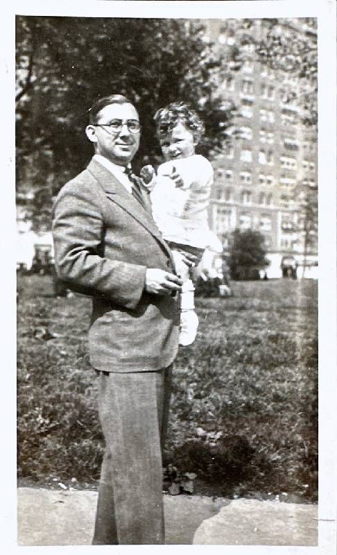 An old photo of A man holding a young girl on his hip. Next Avenue