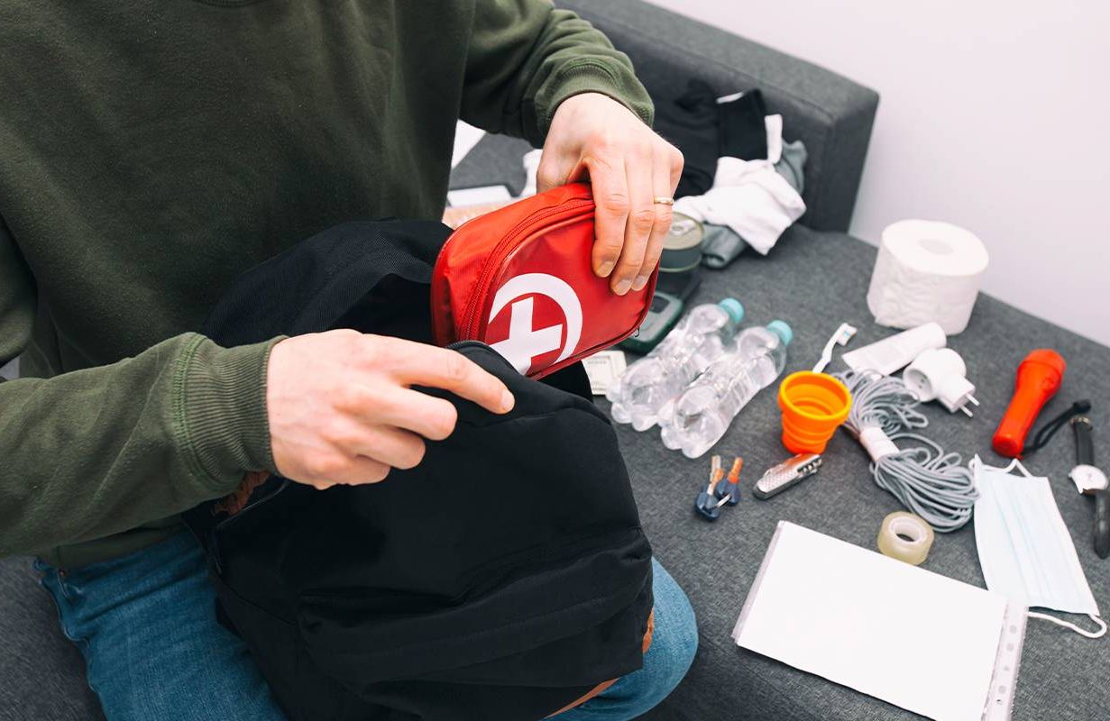 A person packing up items in their "go bag" in case of an emergency. Next Avenue