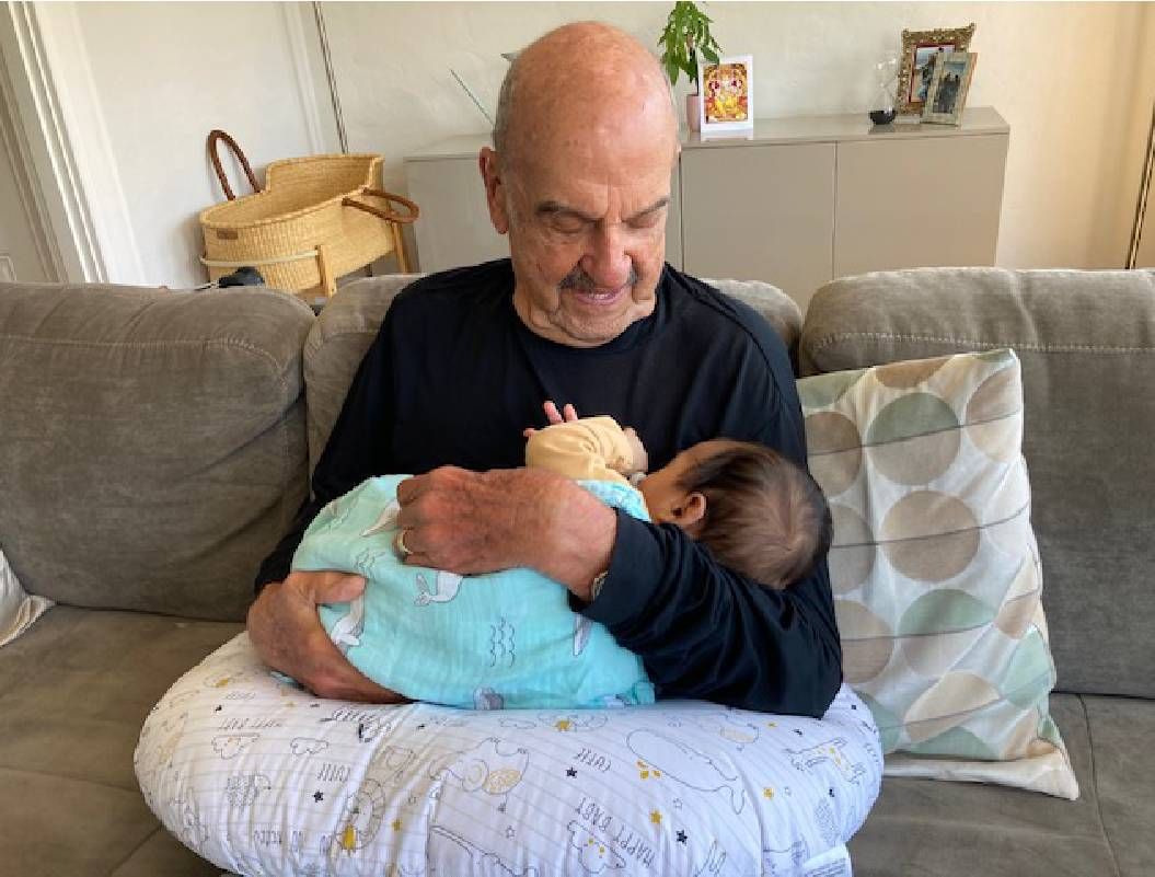 An older adult holding his great-grandchild. Next Avenue
