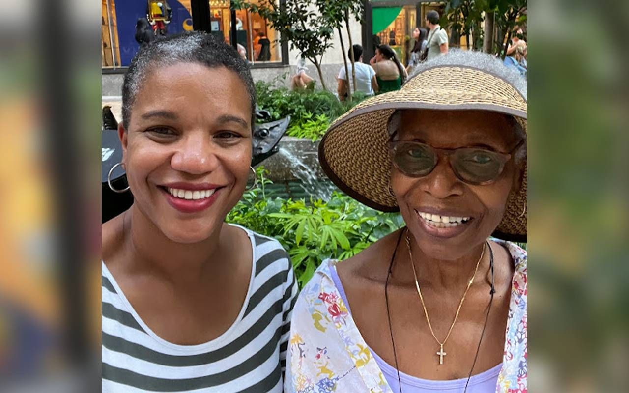A mother and daughter smiling on a nyc street. Next Avenue