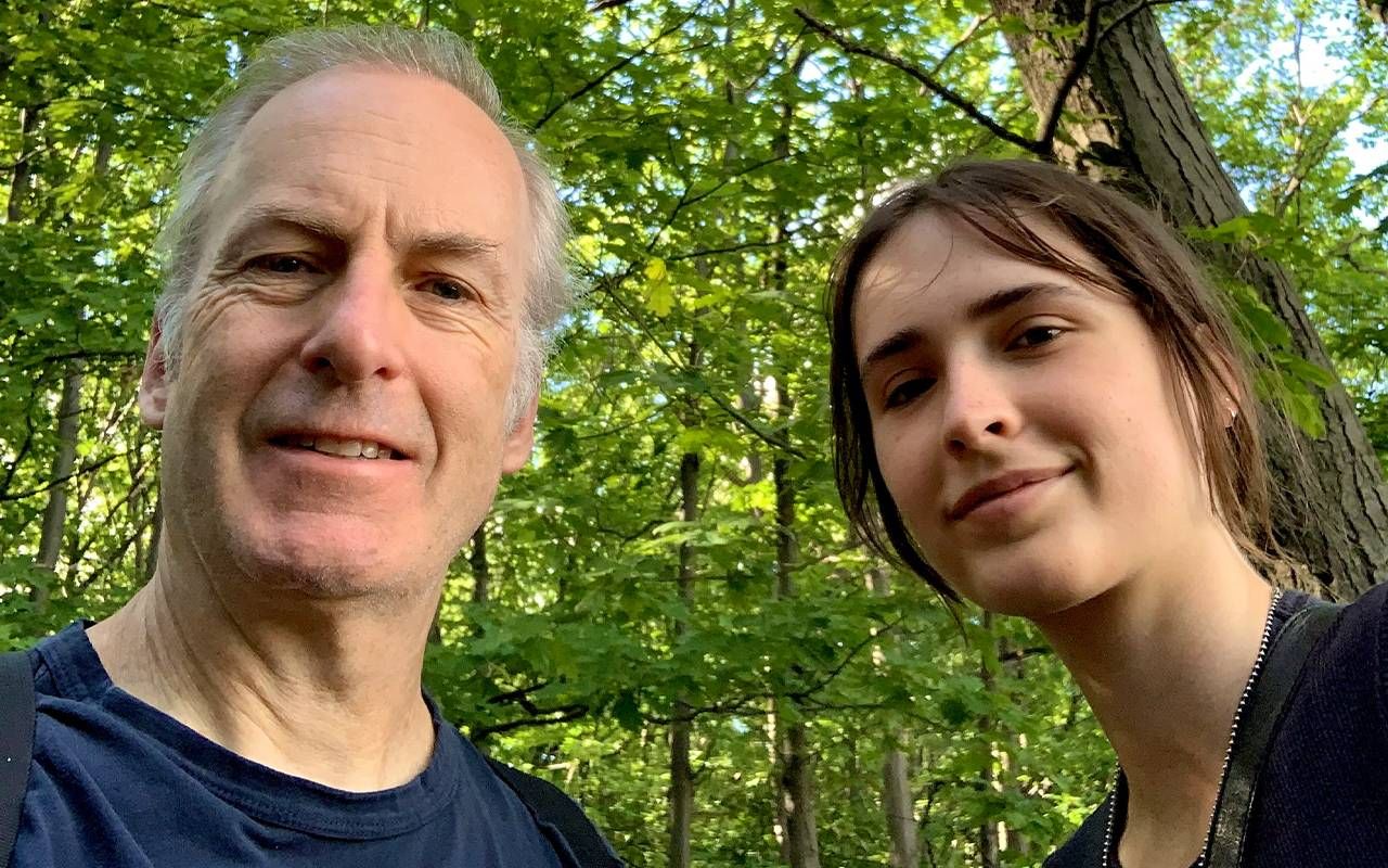 A middle aged man and his daughter in a green forest. Next Avenue