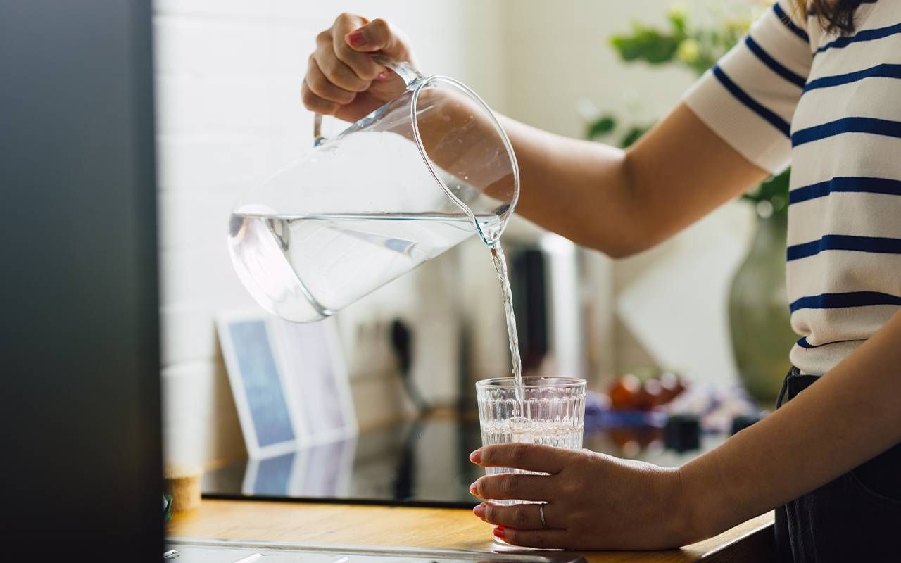 A person pouring a glass of water. Next Avenue