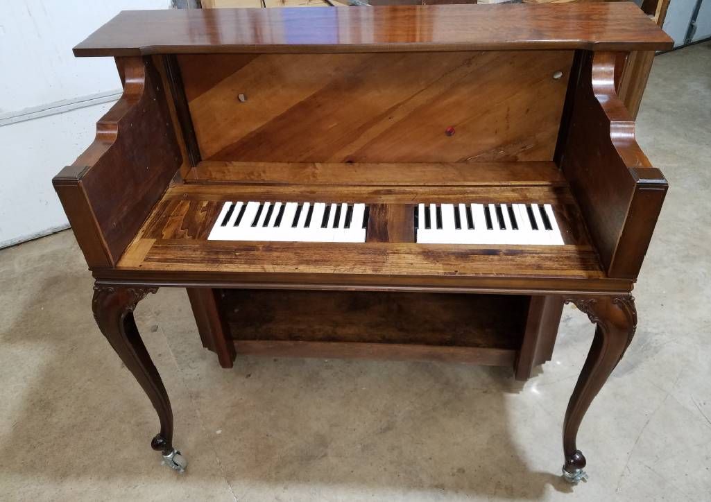 A grand piano that has been turned into a desk. Next Avenue