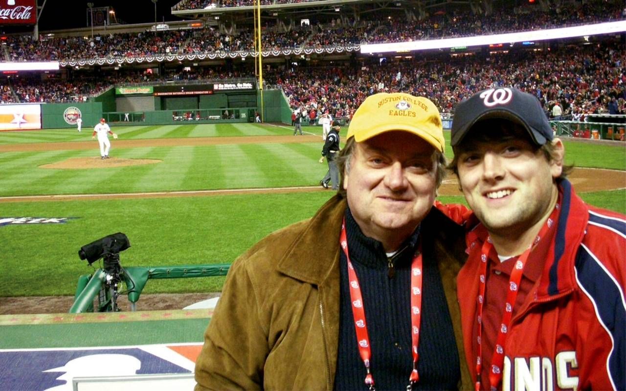 A father and son at a baseball game. Next Avenue, Tim Russert
