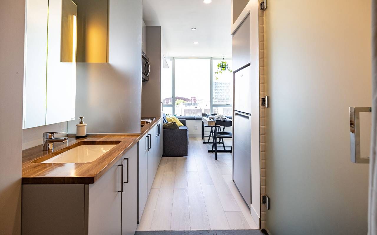 A small hallway leading into a dining room. Next Avenue