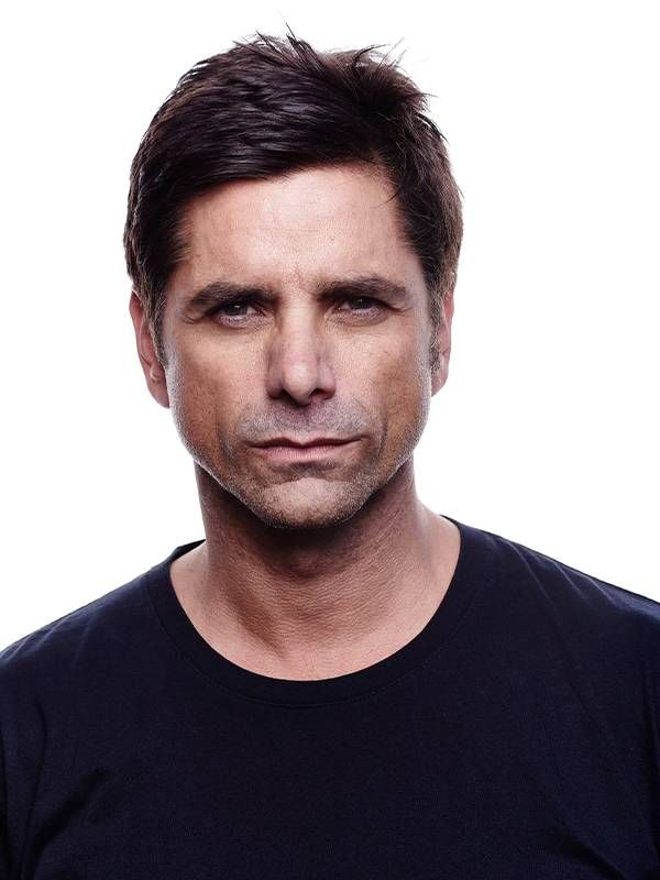 Headshot of a man wearing a black T-Shirt. Next Avenue, John Stamos