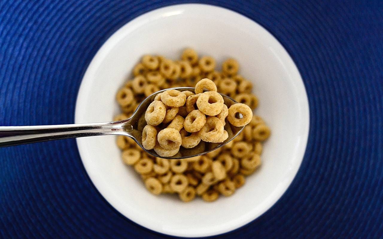 A close up of a spoon filled with Cheerios. Next Avenue