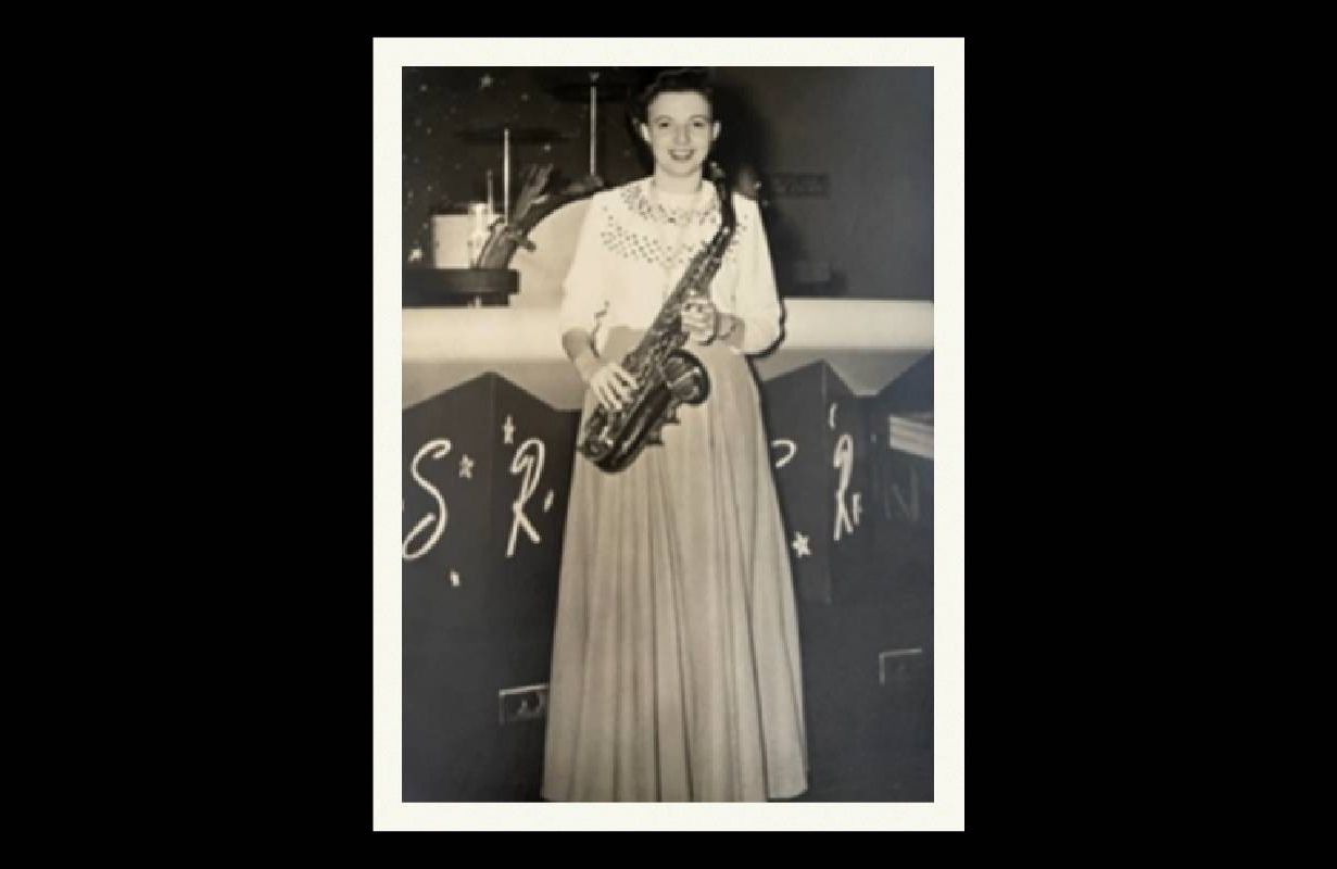 An old photograph of a woman holding her saxophone. Next Avenue