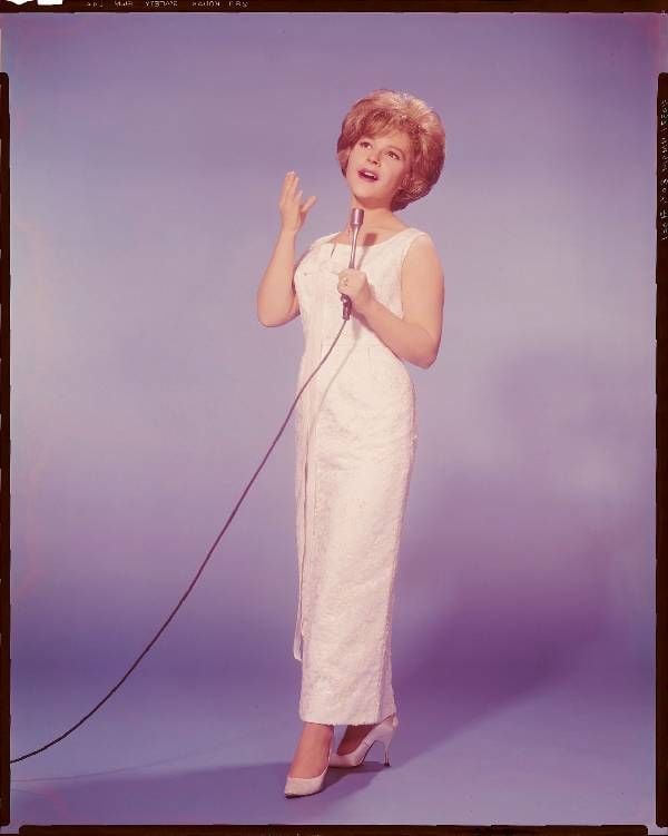 A vintage photo of Brenda Lee holding a microphone. Next Avenue