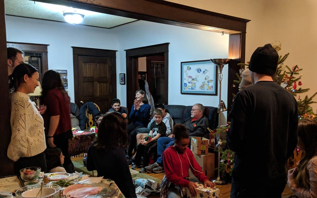 A group of people opening gifts in Christmas morning. Next Avenue
