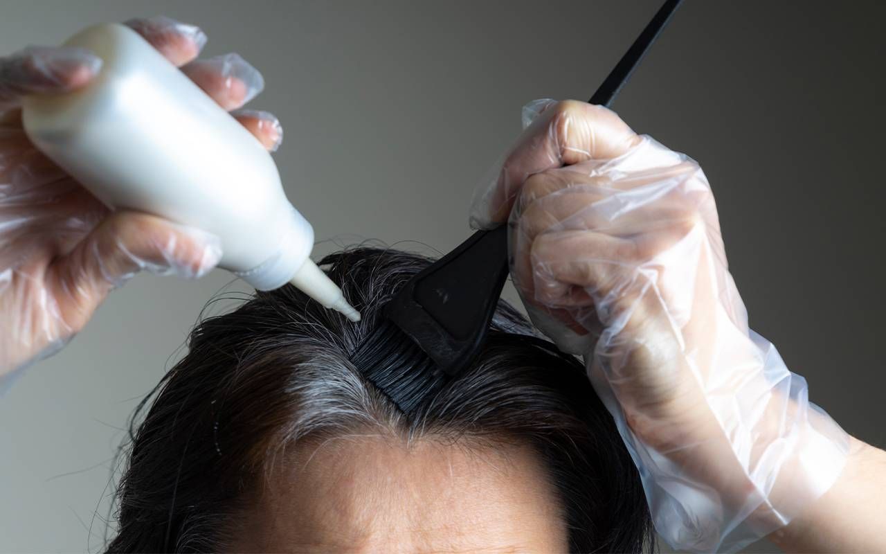 A person using hair dye to dye their gray hair. Next Avenue, going gray