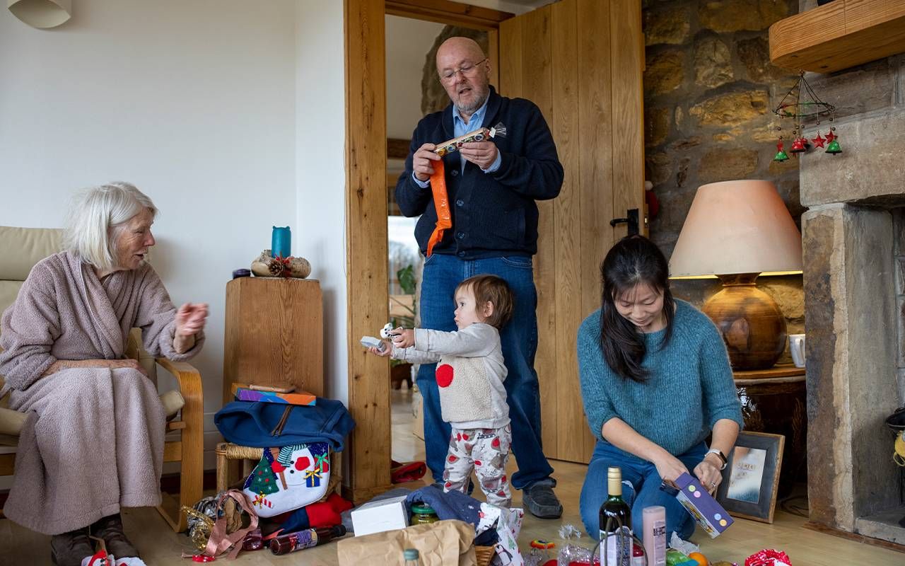 A family celebrating together on Christmas morning. Next Avenue