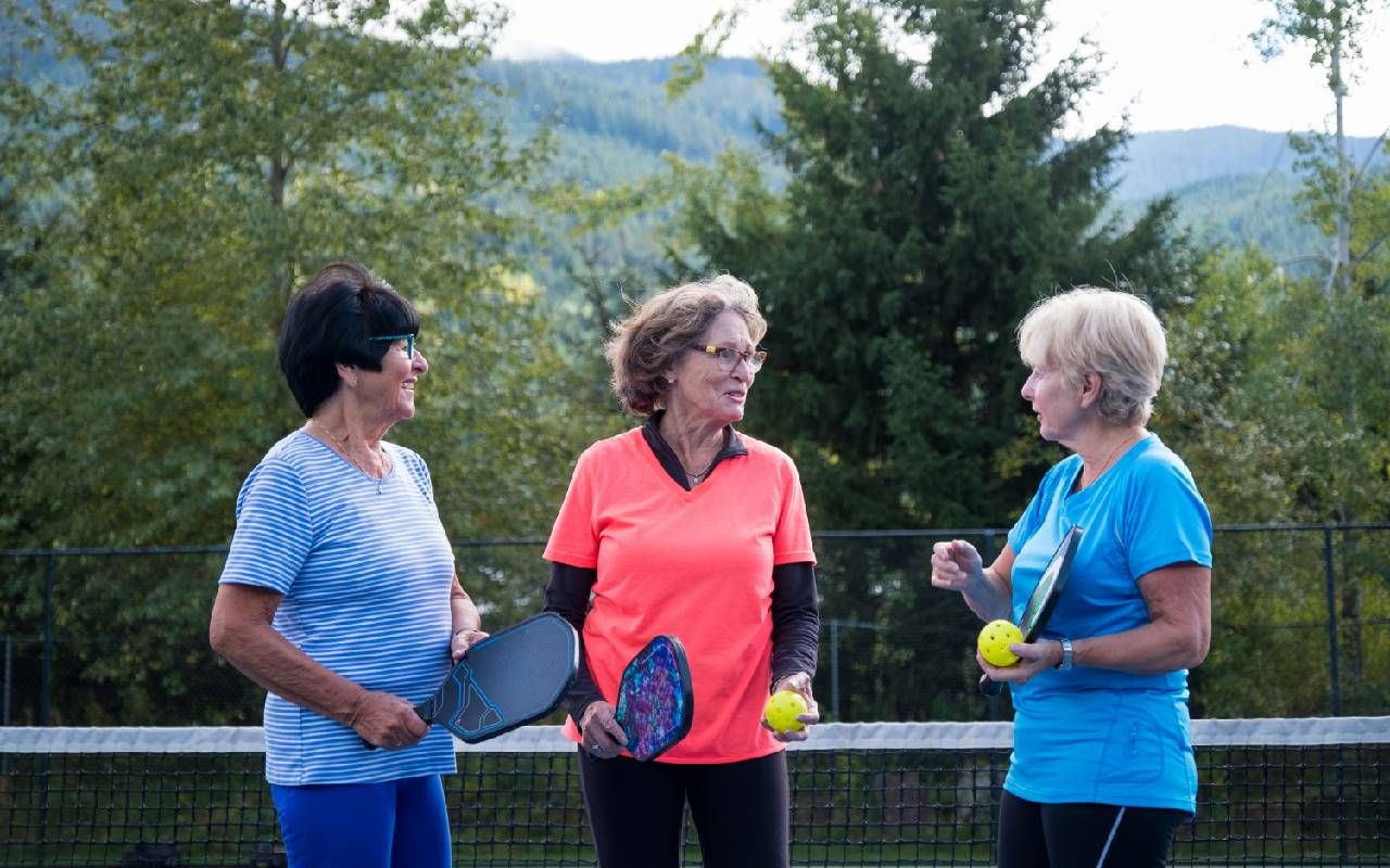 Three friends playing pickleball. Next Avenue