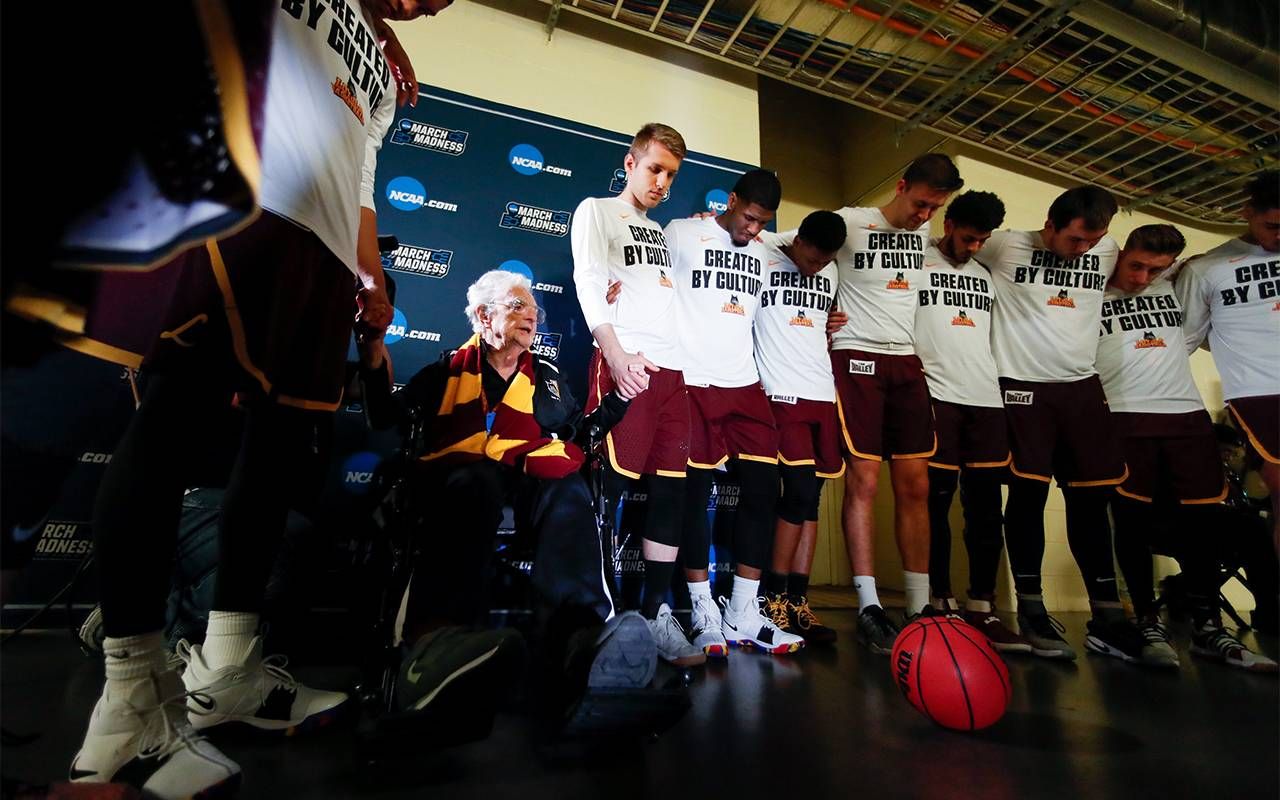 Sister Jean praying with a team before a game. Next Avenue