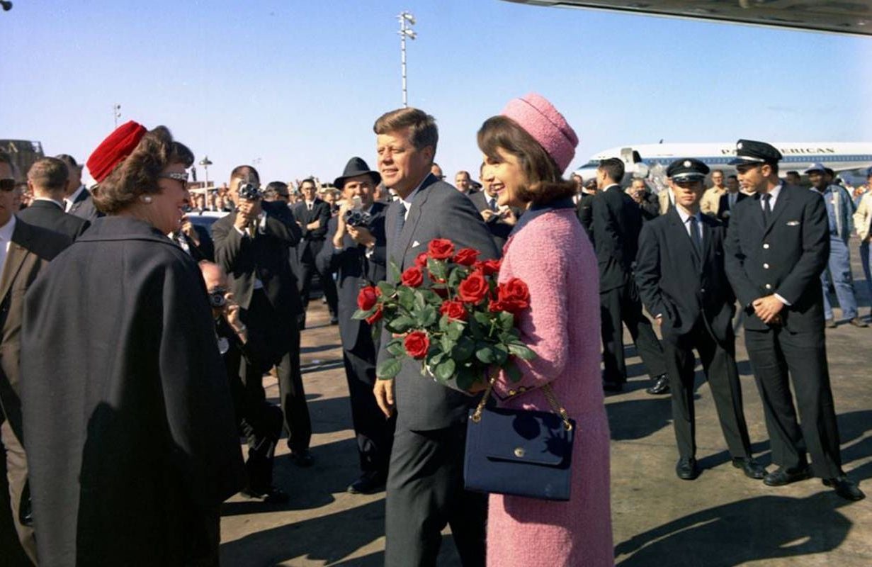 Two people being greeted on an airport tarmac. Next Avenue, Sixty Years jfk Assassination
