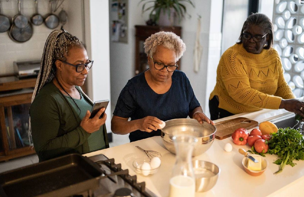 Three sisters with a sibling rivalry cooking together as caregivers. Next Avenue