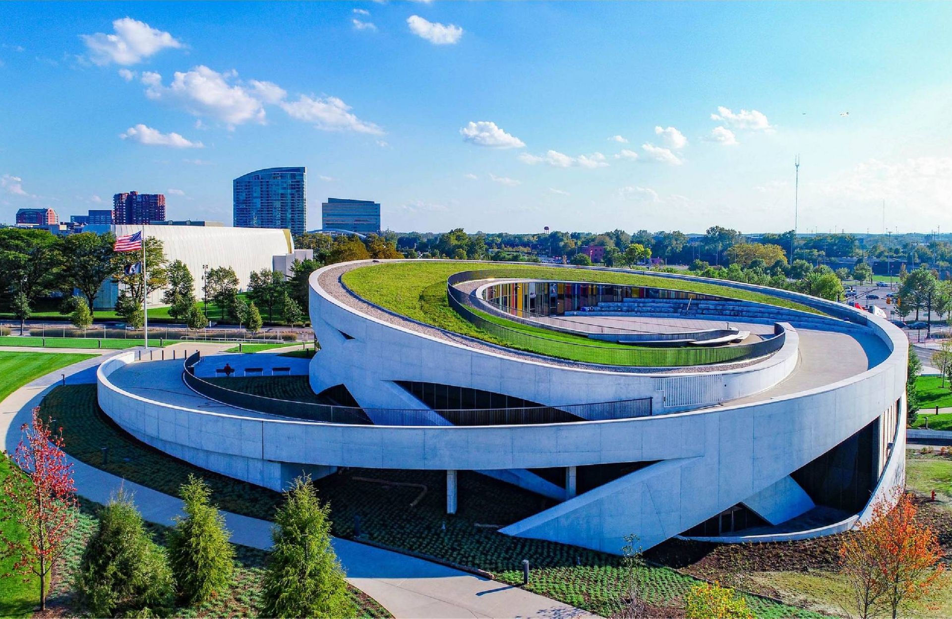 Exterior of a circular building with a ramp up to a green roof. Next Avenue, national veterans memorial and museum
