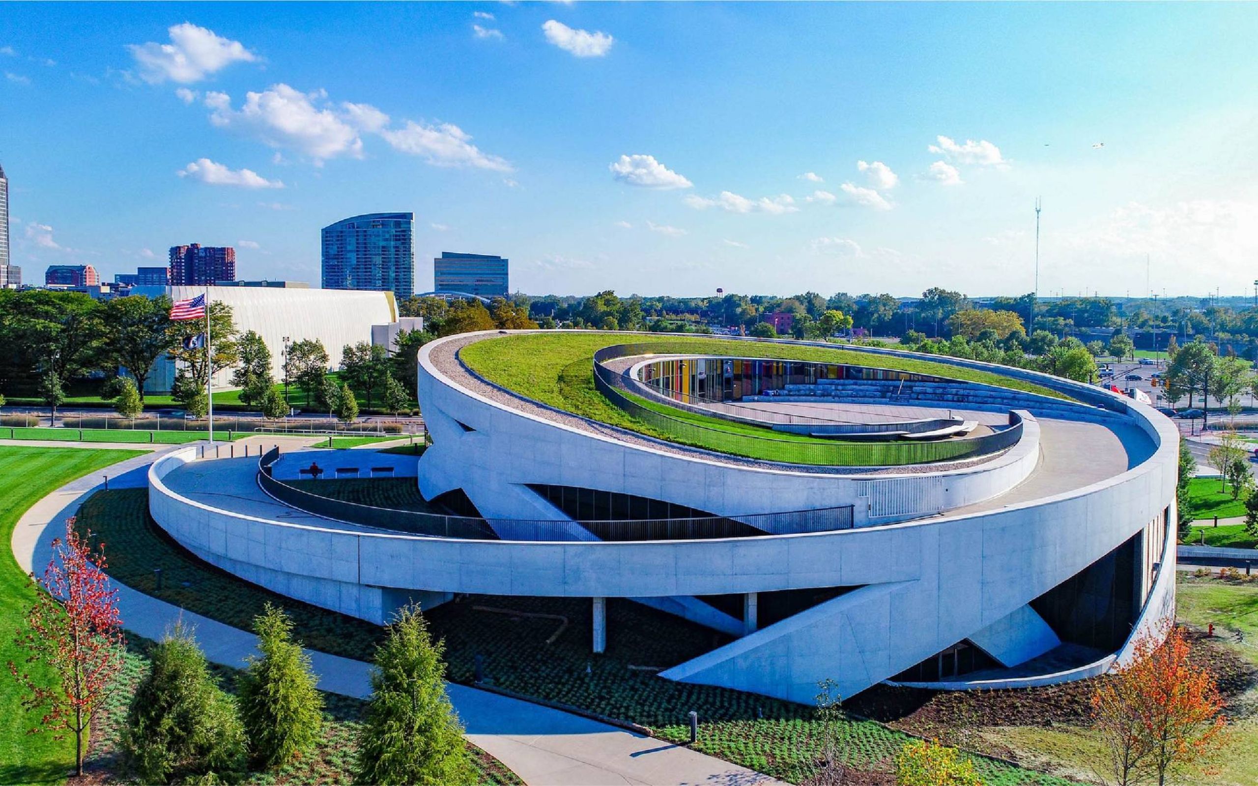 Exterior of a circular building with a ramp up to a green roof. Next Avenue, national veterans memorial and museum
