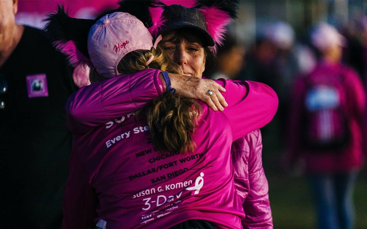 Two women wearing pink hugging. Next Avenue, breast cancer