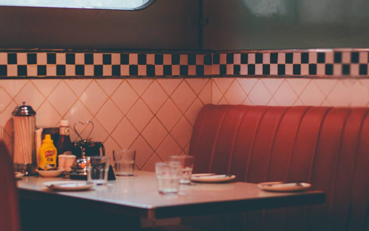 An empty diner booth in a classic diner. Next Avenue, flirting, after 50
