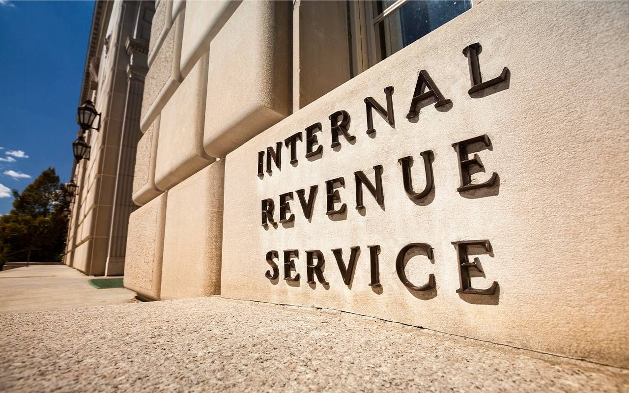 A building with a sign for the IRS on the outside. Next Avenue