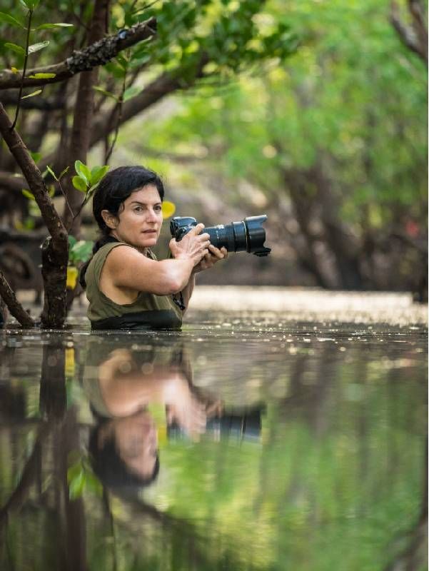 A photographer wading in a swamp. Next Avenue, Seeing It All: Women Photographers Expose Our Planet