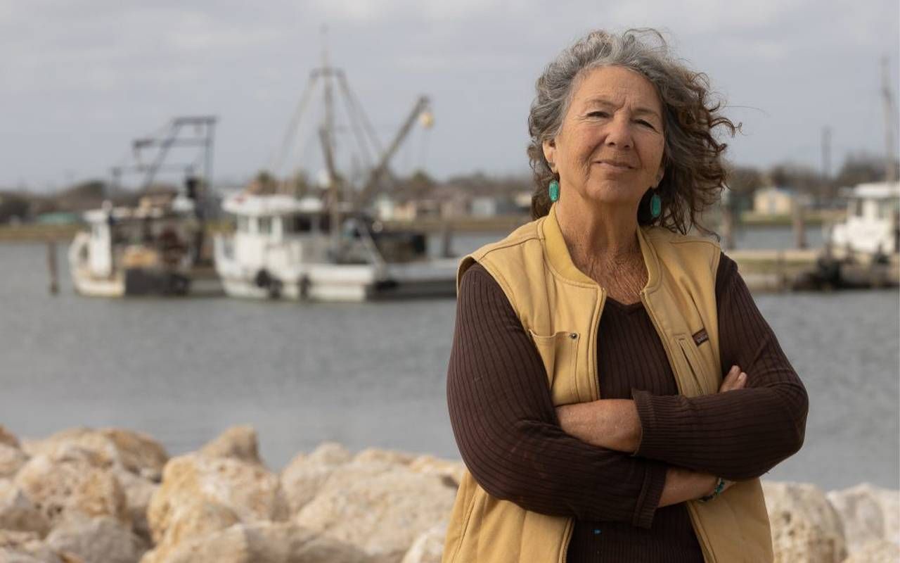 Headshot of a woman in front of shrimping boats. Next Avenue