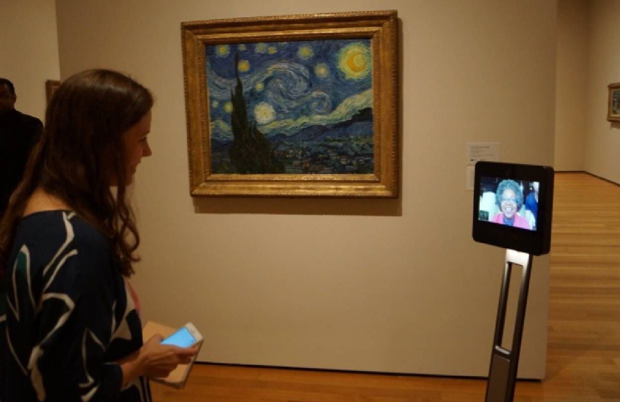 A person using a video robot to view various artwork at a museum. Next Avenue