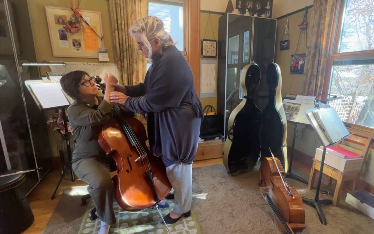 A woman and her cello teacher during a lesson