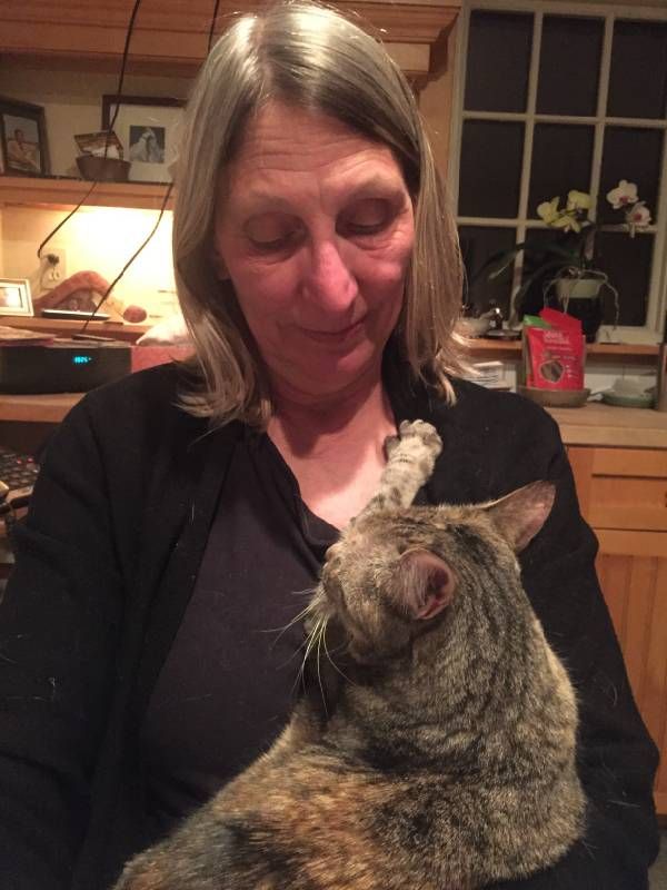 A woman holding a cat. Next Avenue, adopting pets