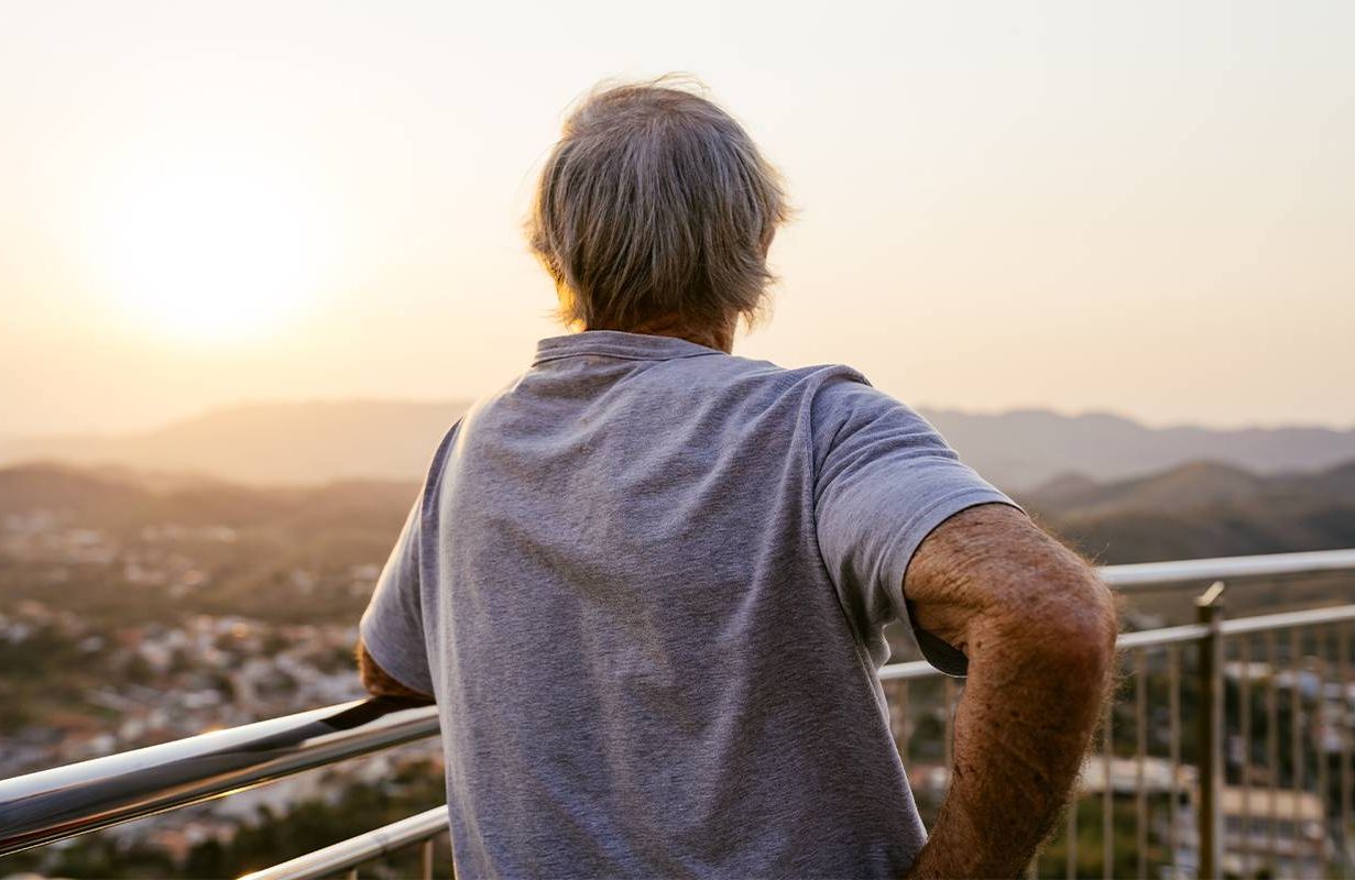 A man looking out at the sunrise. Next Avenue, aging, loss, grief