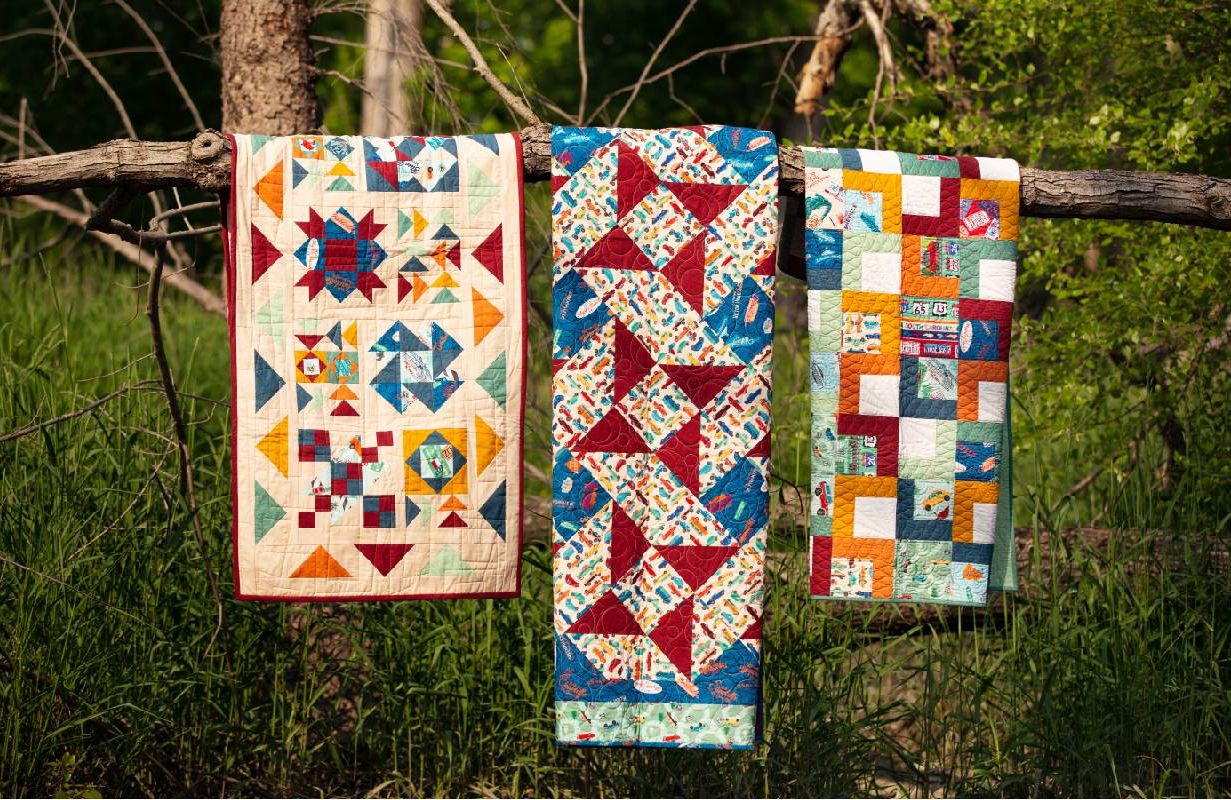 Three quilts on a tree branch. Next Avenue, quilting